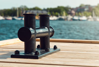 Close-up of pier on table against sea