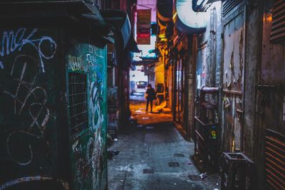 Alley amidst buildings at dusk