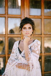 Portrait of young woman standing outdoors