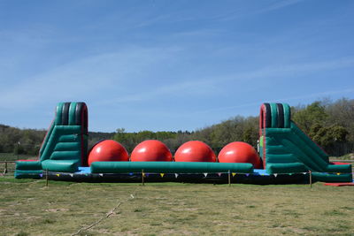 Multi colored air mattress against blue sky