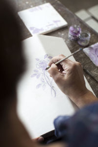 Close-up of person decorating stove tile