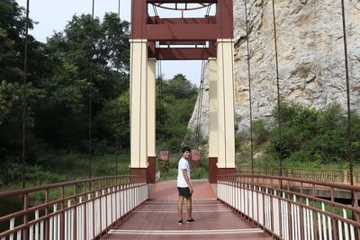 Man standing on bridge