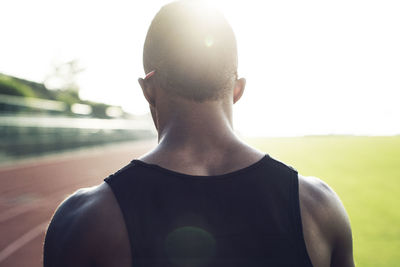 Rear view of male athlete on field