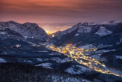 Scenic view of mountains against sky at sunset