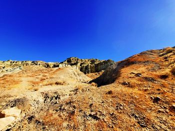 Scenic view of mountain against blue sky