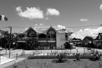 Houses and buildings in town against sky