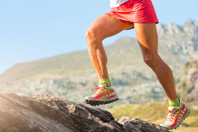 Legs of skyrunner woman with muscles and veins in action.