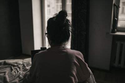 Rear view of woman at home