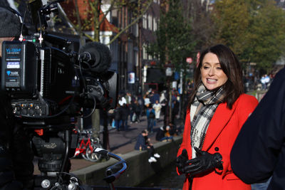 Young woman photographing with camera