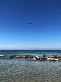 Scenic view of sea against clear blue sky