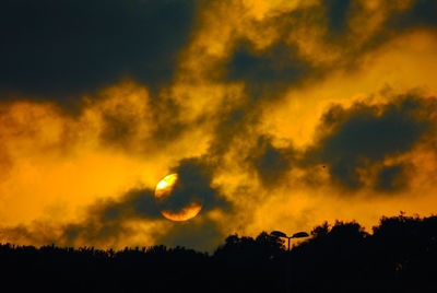 Low angle view of silhouette trees against sky at sunset