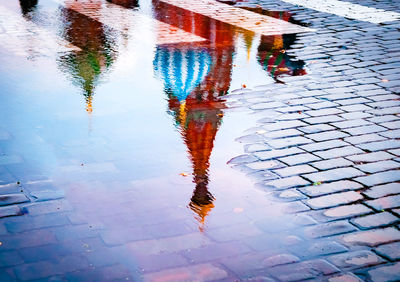 High angle view of puddle on street during rainy season