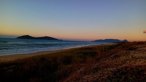 Scenic view of sea against clear sky during sunset