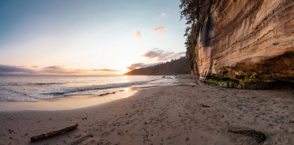 Scenic view of beach against sky during sunset