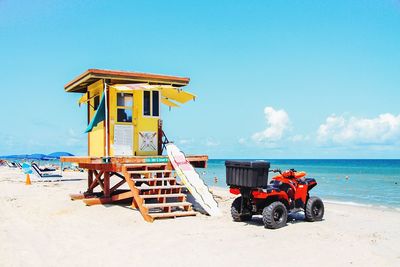 Lifeguard hut on beach against sky