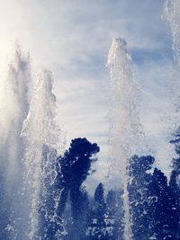 Water splashing in sea against sky