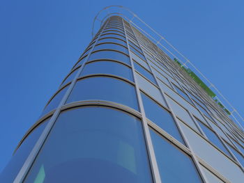 Low angle view of modern building against clear blue sky