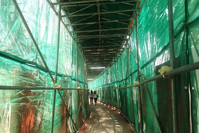 Rear view of woman walking on corridor