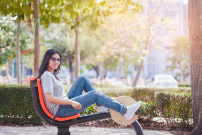 Portrait of smiling young woman sitting outdoors