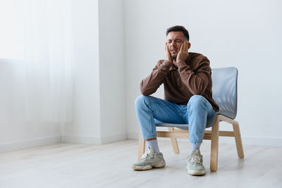 Young woman sitting on floor at home