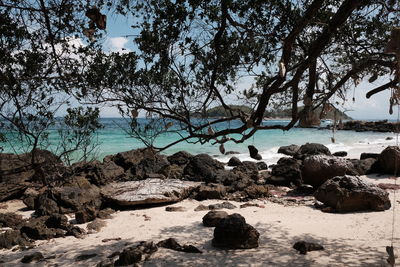 Rocks on beach against sky
