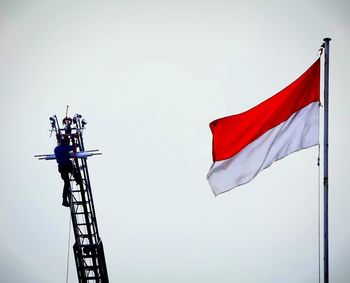 Low angle view of flag against clear sky