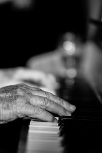 Close-up of hands playing piano