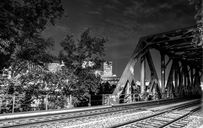 Railway bridge against sky during night