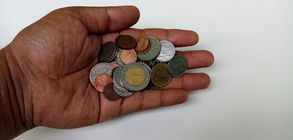 High angle view of hand holding coin