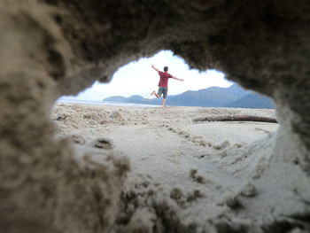 Full length of woman walking on beach