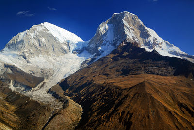 Snowcapped mountains against blue sky