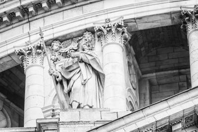 Low angle view of statue against historic building