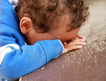 Boy sleeping lying down stock photo