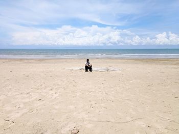 Man on beach against sky