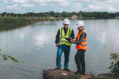 Technicians and engineers discuss work together working at water recycling plant for reuse