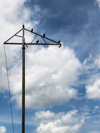 Low angle view of crane against sky