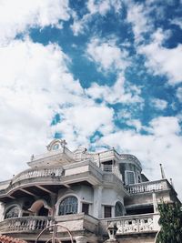 Low angle view of building against cloudy sky