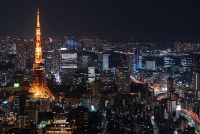 Illuminated cityscape against sky at night