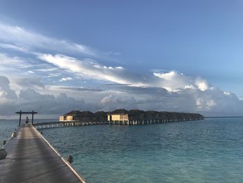 Scenic view of sea by buildings against sky