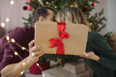 Couple holding christmas tree