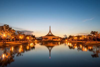 Reflection of building in lake at dusk