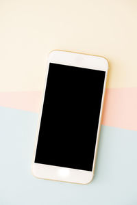 Close-up of mobile phone against white background