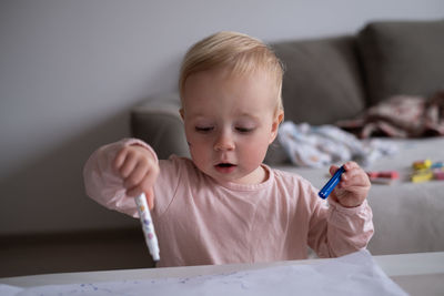 Cute girl painting on table