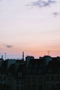 Exterior of residential buildings against sky during sunset