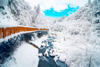 View of footbridge over snow covered land during winter