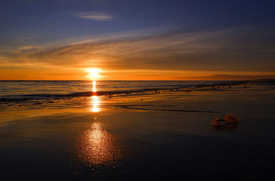 Coastal sunrise reflections on the beach 