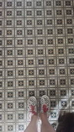 Low section of man on tiled floor