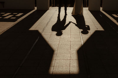 Shadow of man walking on street