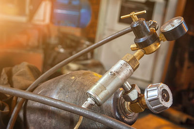 Close-up of a metal gas cylinder with a reducer and a pressure sensor 