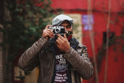 Portrait of young man photographing